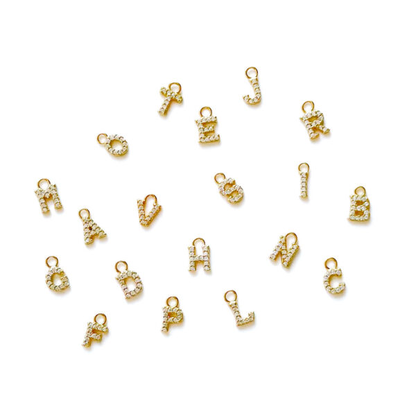 "High-resolution image of A charm - Elevate your personal style with our exquisite gold letter charm adorned with sparkling zirconias. Crafted with precision and attention to detail, this elegant charm is the perfect addition to your jewelry collection. Whether it's to commemorate a special occasion or add a touch of personalized glamour, our letter charm with zirconias is designed to captivate. Details: Sterling silver 925 Pure white zirconias "